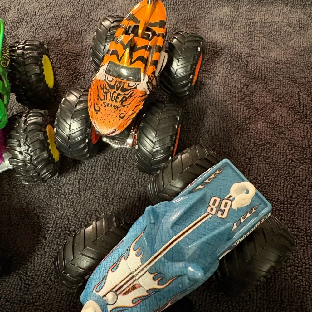 Hot Wheels 4 lot of Monster Truck Toys. Assorted Colors (Green, Orange, Blue)